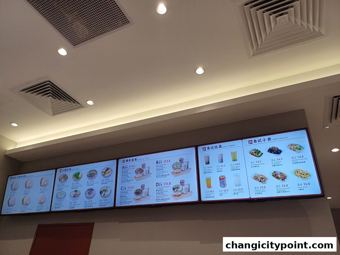 A digital menu board displaying various food and drink items with prices.