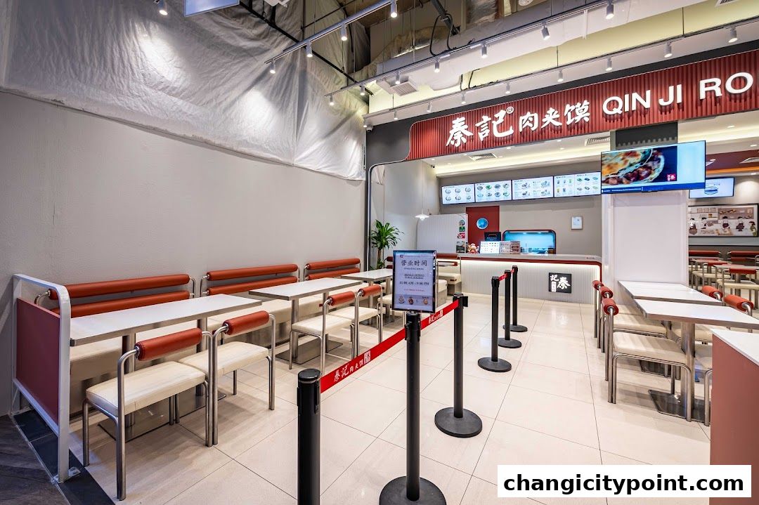 Interior view of Qin Ji Rougamo fast food restaurant with seating and counter.