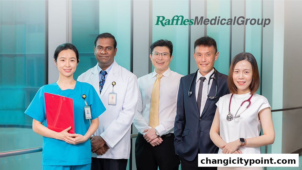 A diverse team of medical professionals from Raffles Medical Group posing for a photo.