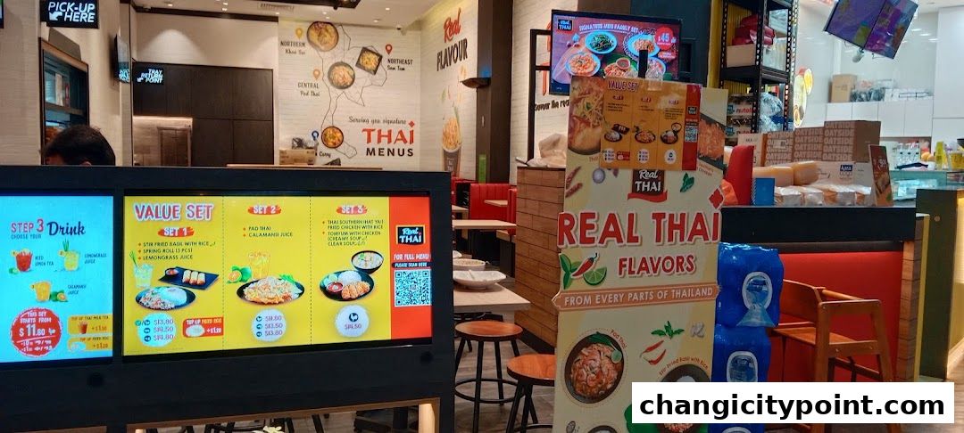 Digital menu boards display Thai food value sets and drink options at Real Thai.