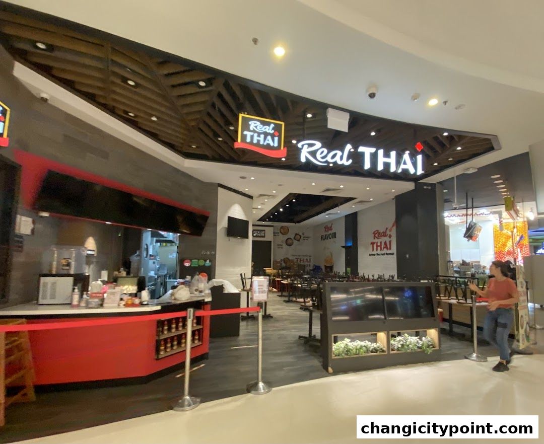 The exterior of a Real Thai restaurant with its prominent signage and seating area.