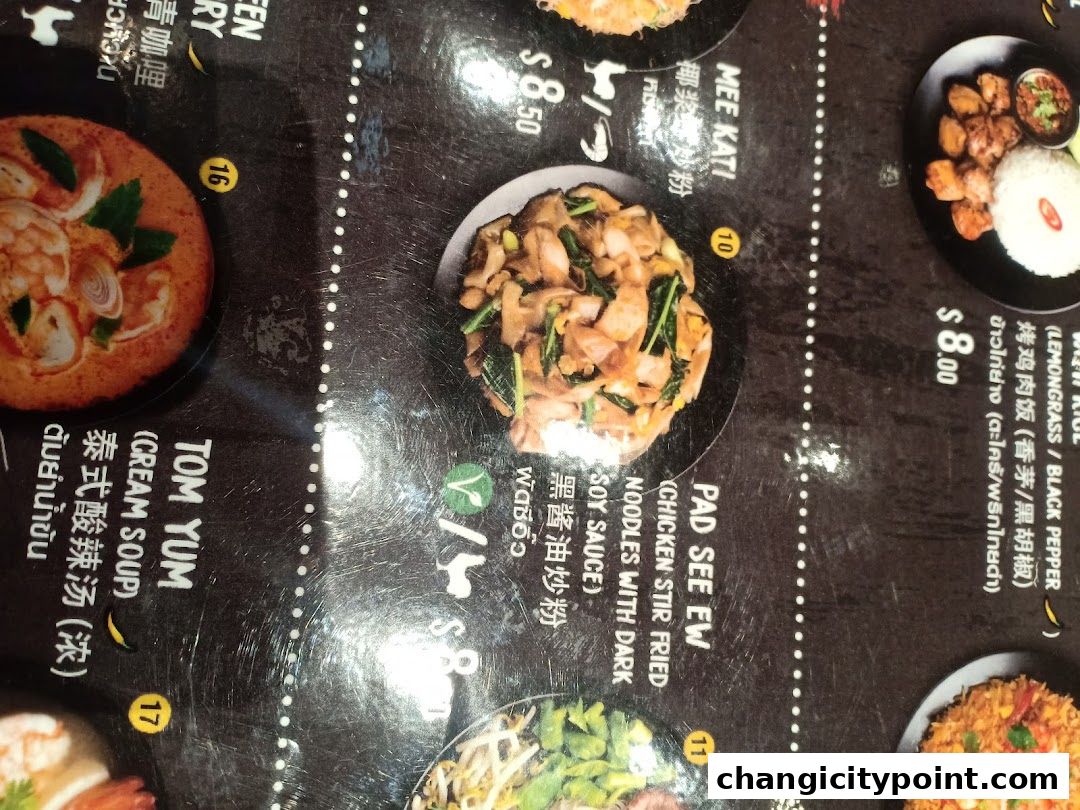 A close-up of a Thai food menu featuring various dishes with descriptions and prices.
