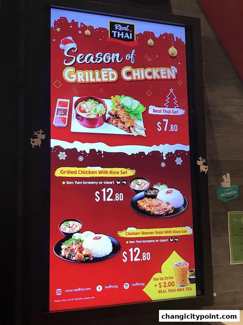 A digital menu board advertising Real Thai's Season of Grilled Chicken specials.