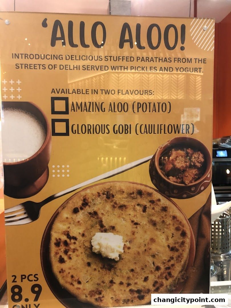 A sign advertising stuffed parathas with two flavor options and pricing.
