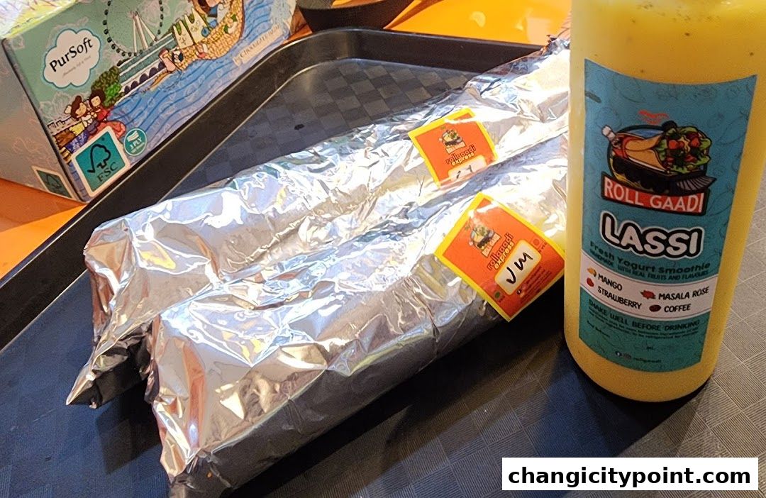 Two foil-wrapped rolls and a bottle of Lassi from Roll Gaadi.