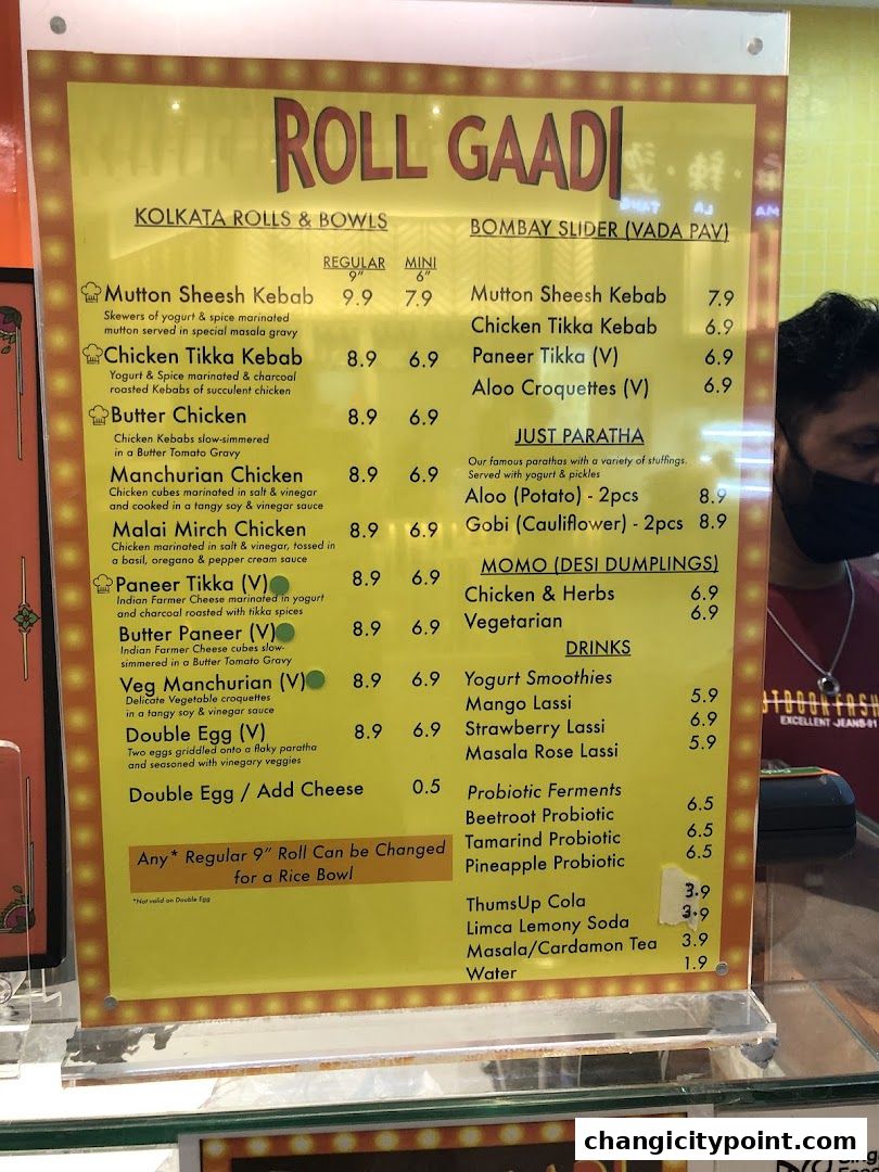 A menu board for Roll Gaadi, featuring Kolkata Rolls & Bowls and Bombay Sliders.