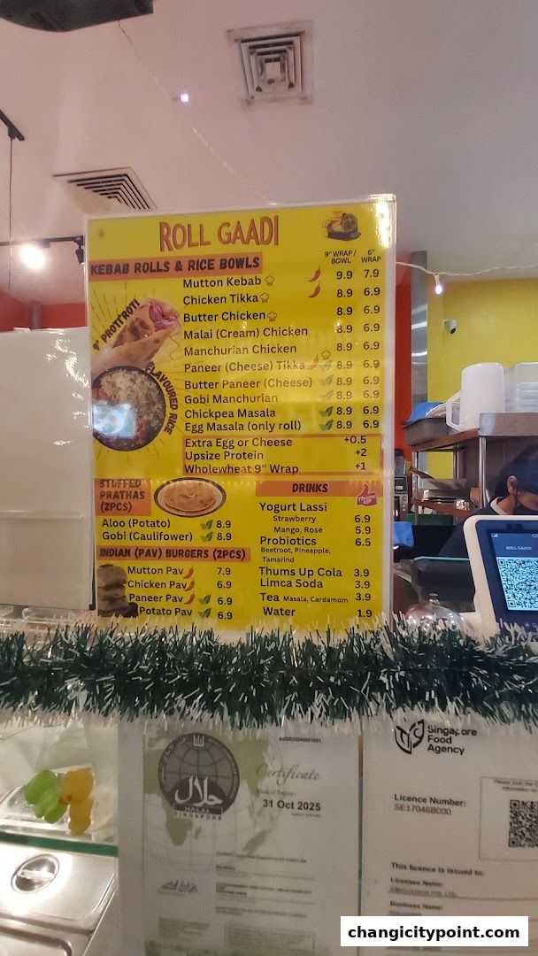 A menu board for Roll Gaadi, featuring kebab rolls, rice bowls, stuffed prathas, burgers, and drinks.