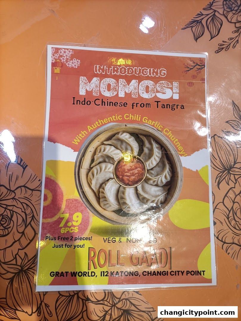 A menu introducing Momos from RollGaadi, featuring Indo-Chinese cuisine with chili garlic chutney.
