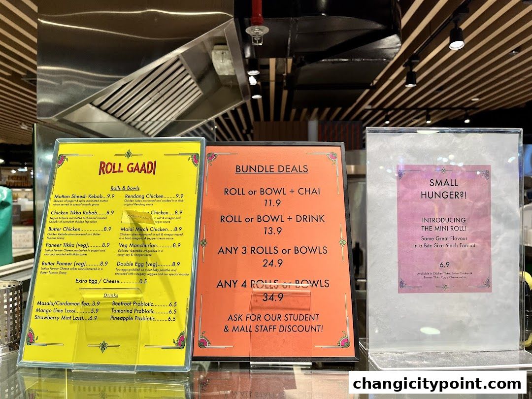A menu board for Roll Gaadi, featuring rolls, bowls, drinks, and bundle deals.