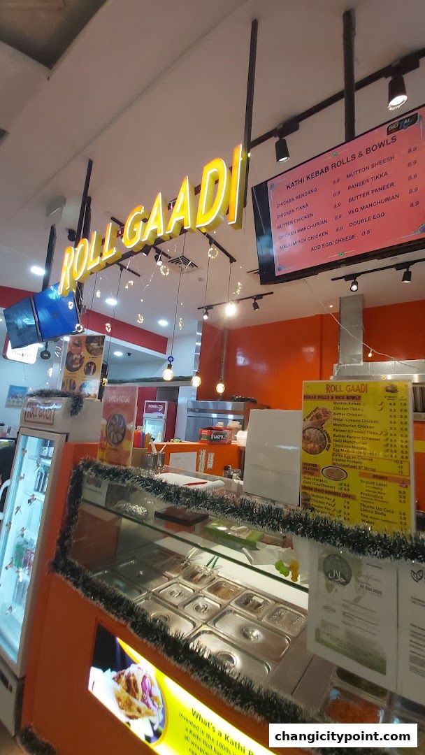 The RollGaadi shop front with illuminated signage and a display counter.