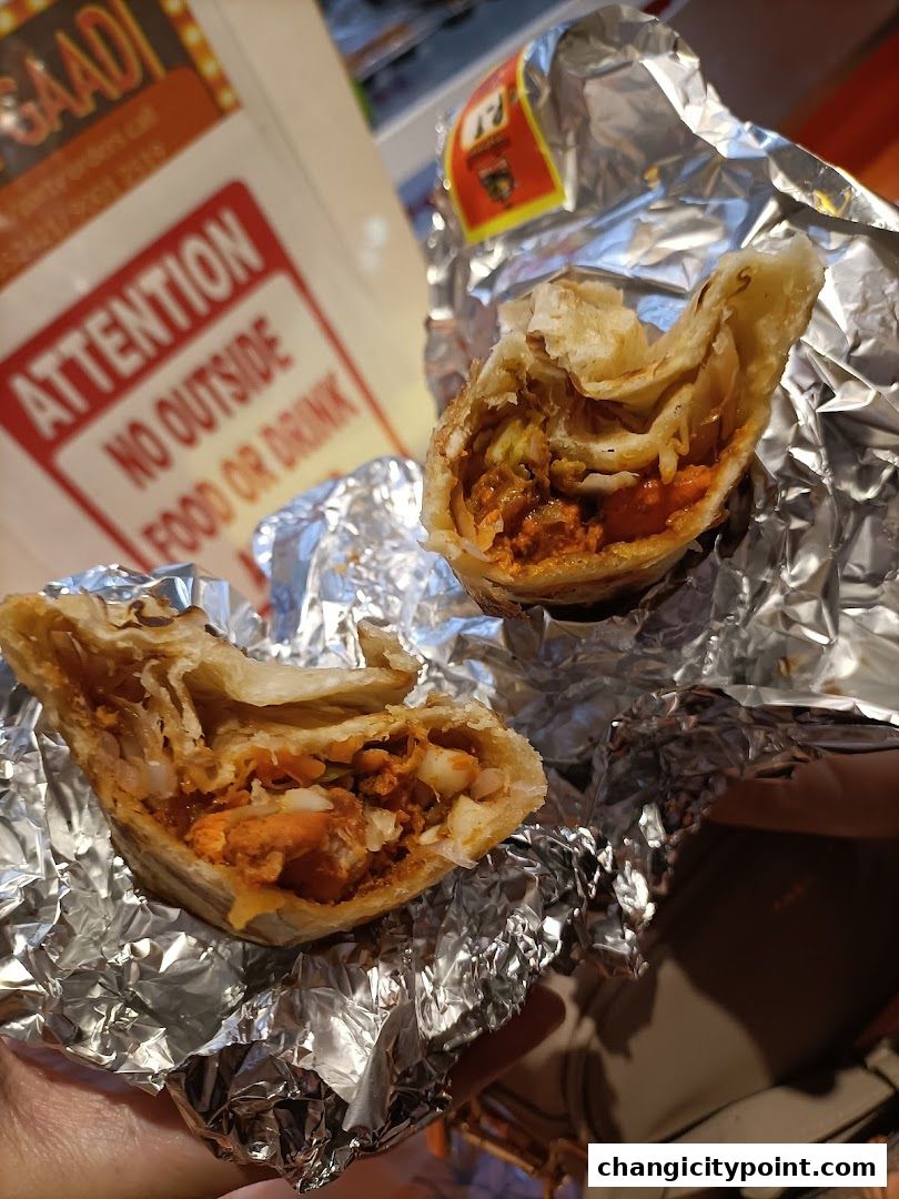 Two delicious rolls from RollGaadi, wrapped in foil, showcasing their savory fillings.