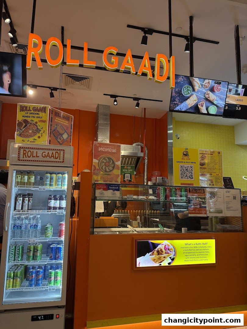The Roll Gaadi shop front with a prominent sign, display fridge, and counter.