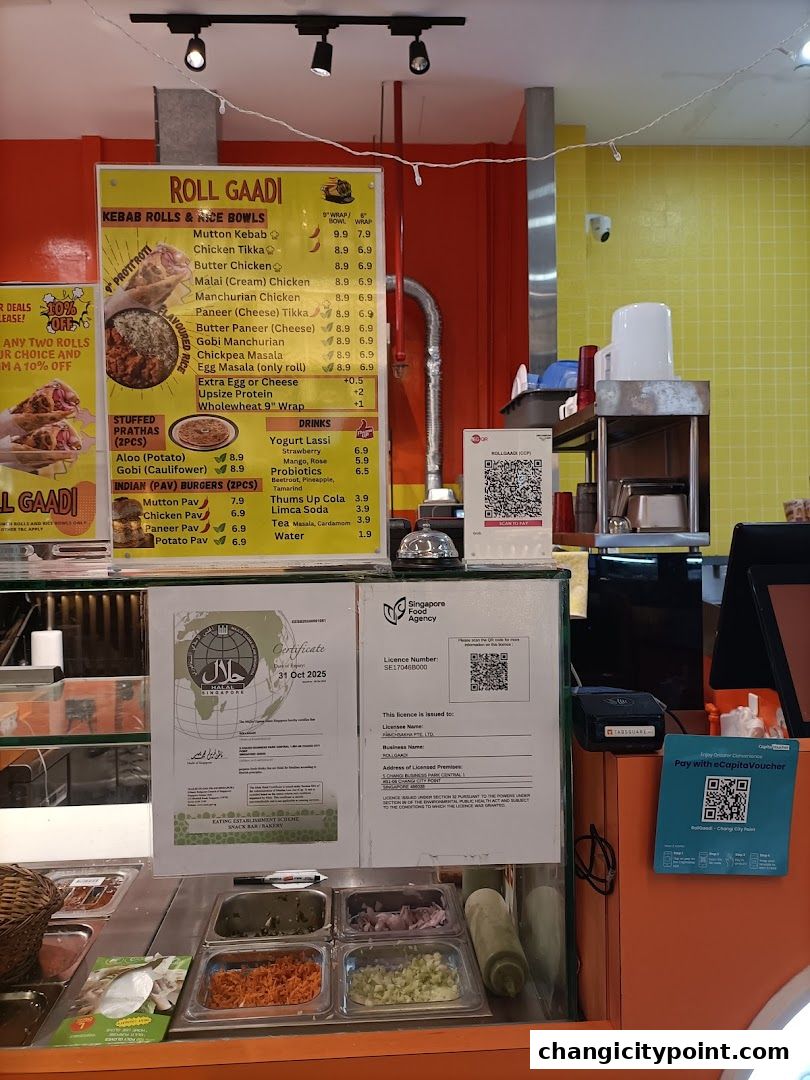 A menu board for RollGaadi, featuring kebabs, rolls, rice bowls, prathas, burgers, and drinks.