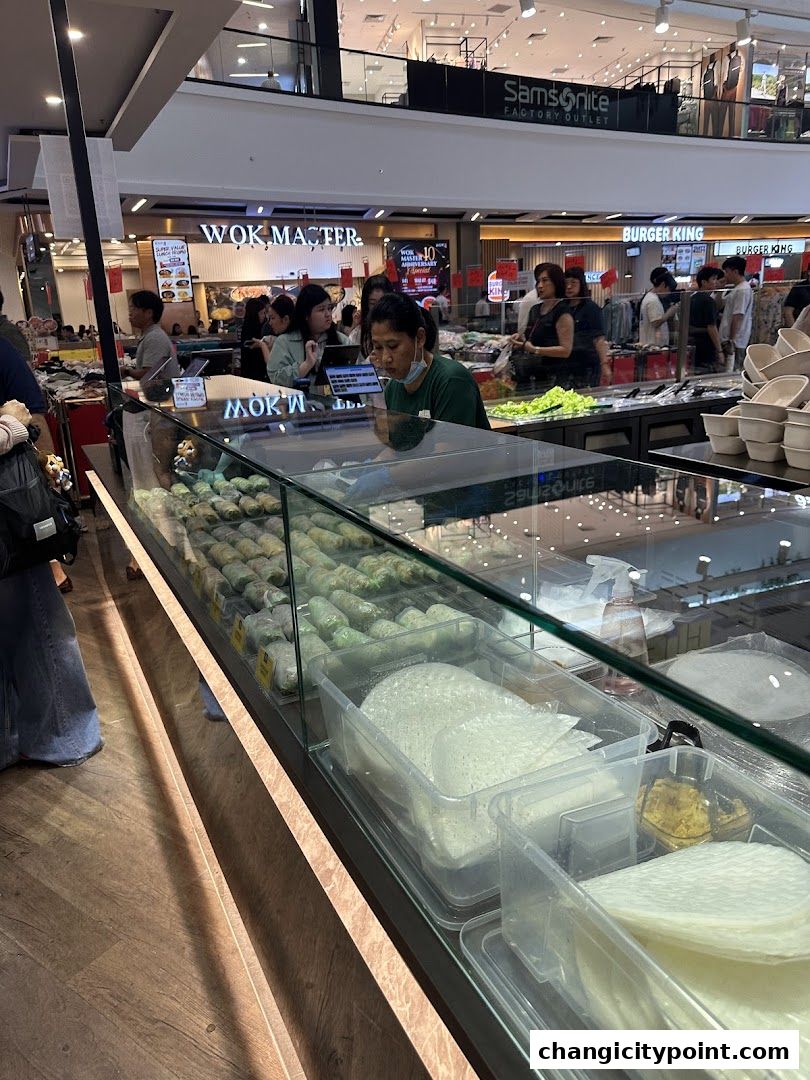 A display case filled with fresh spring rolls and ingredients at Saigon Rolls.