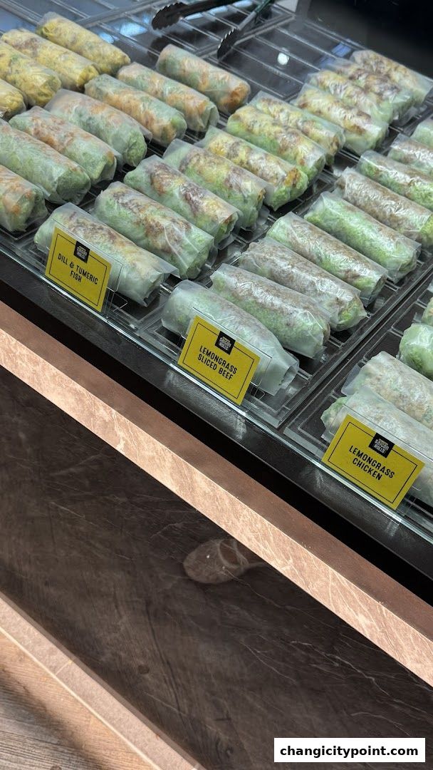 A display case filled with fresh Vietnamese spring rolls, labeled with various fillings.