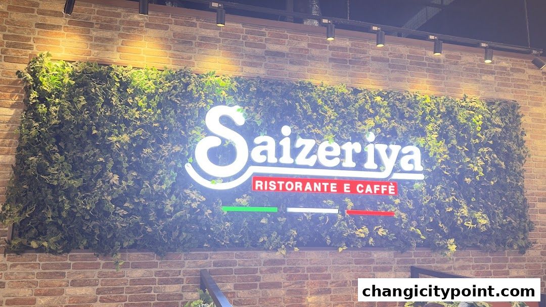 Saizeriya Ristorante e Caffè logo on a brick wall with a green ivy backdrop.