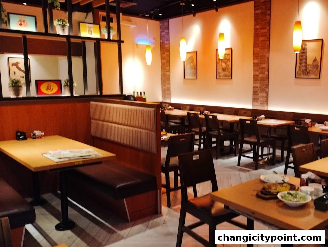 Interior view of a Saizeriya restaurant with tables, chairs, and booths.