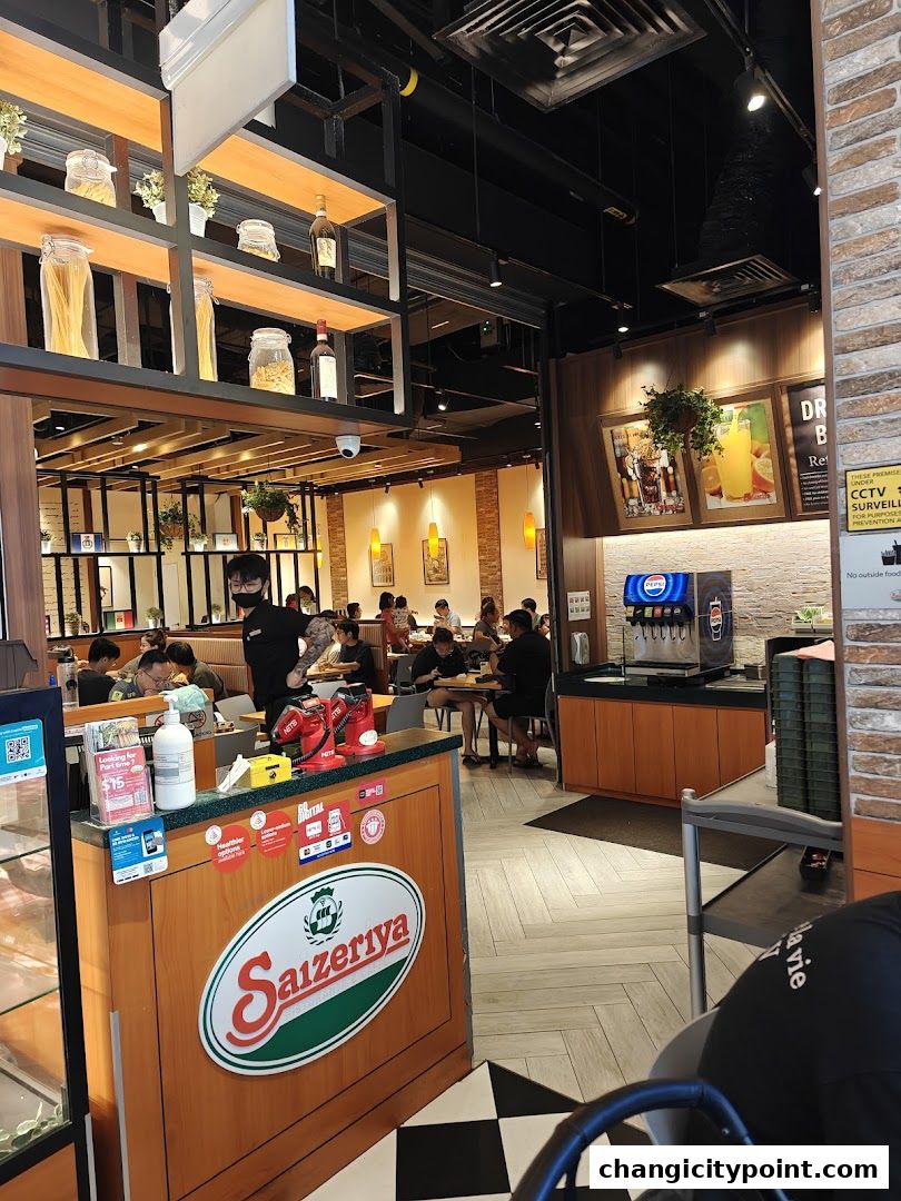 Interior view of Saizeriya restaurant with diners and a counter.