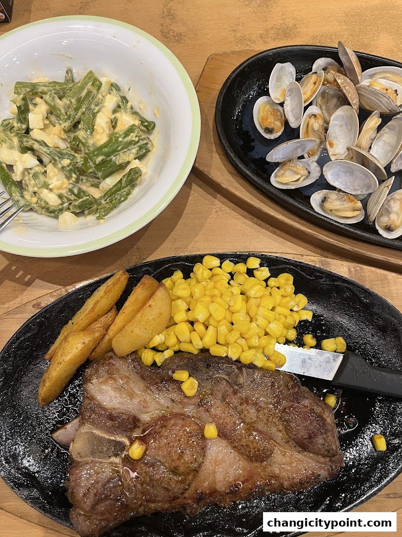 A sizzling steak with corn and fries, served with a side of clam and green bean salad.