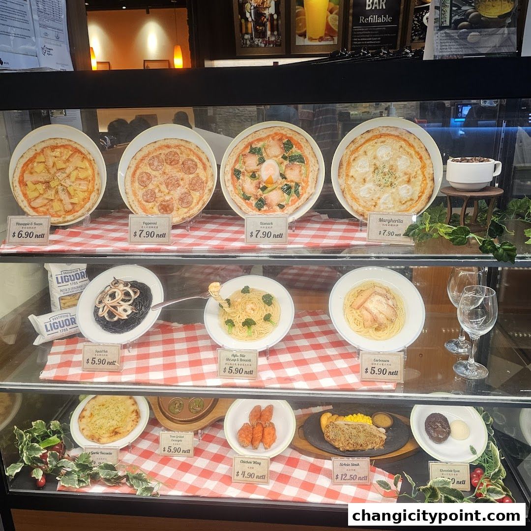 Display case showcasing realistic food models of pizzas, pastas, steak, and desserts.