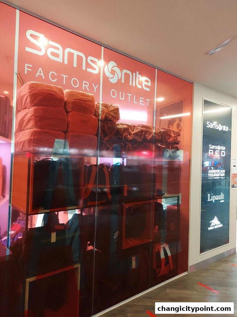 Samsonite Factory Outlet shop front with luggage displayed on shelves and posters.