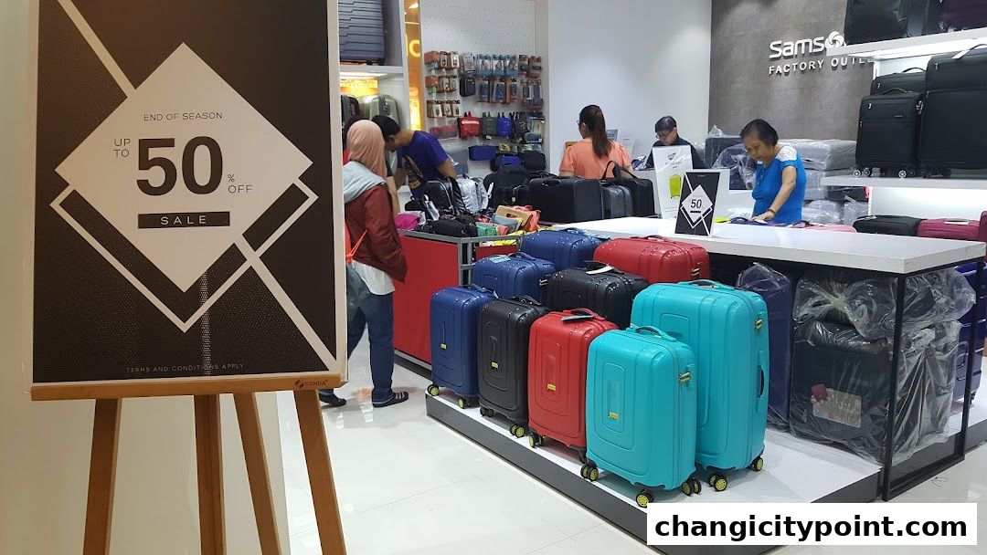 Samsonite Factory Outlet shop with colorful luggage and a 50% off sale sign.