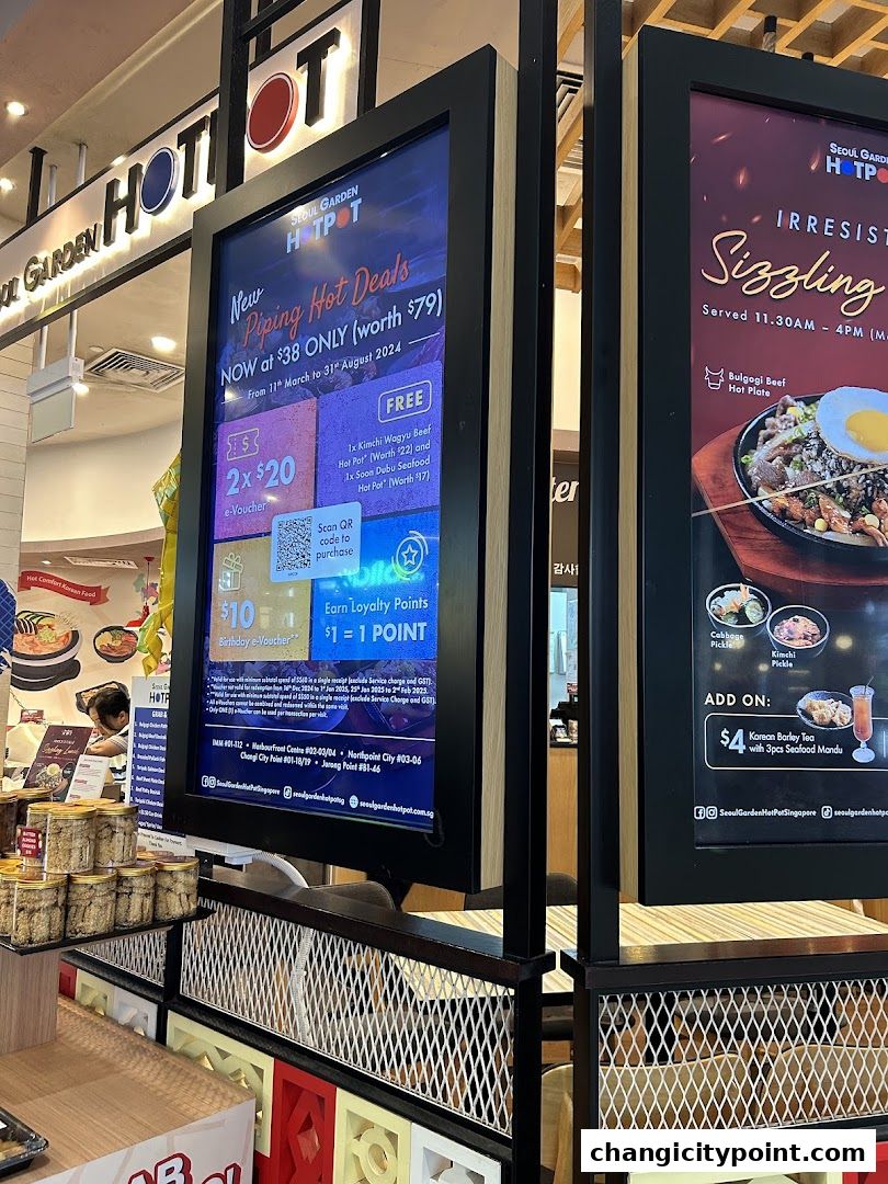 Digital screens display hot pot deals and sizzling dishes at Seoul Garden Hot Pot.