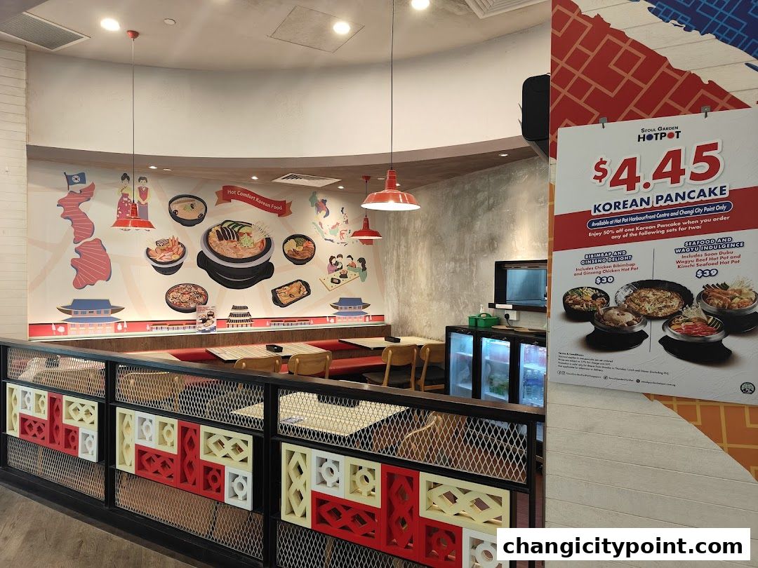 Interior of Seoul Garden Hot Pot with Korean food mural and promotional poster.