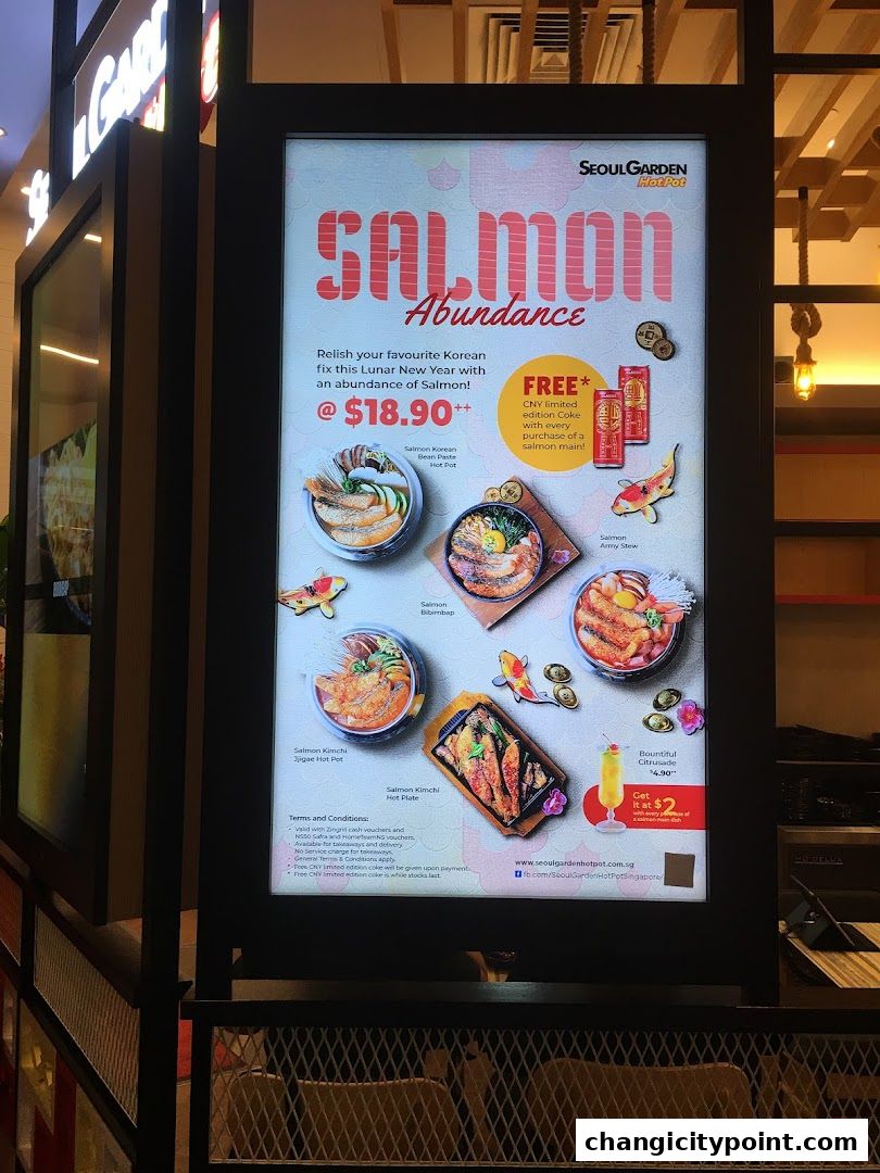 A digital menu board advertising a Salmon Abundance promotion at Seoul Garden Hot Pot.