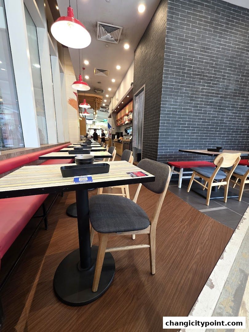 Interior view of Seoul Garden Hot Pot with tables, chairs, and red pendant lights.