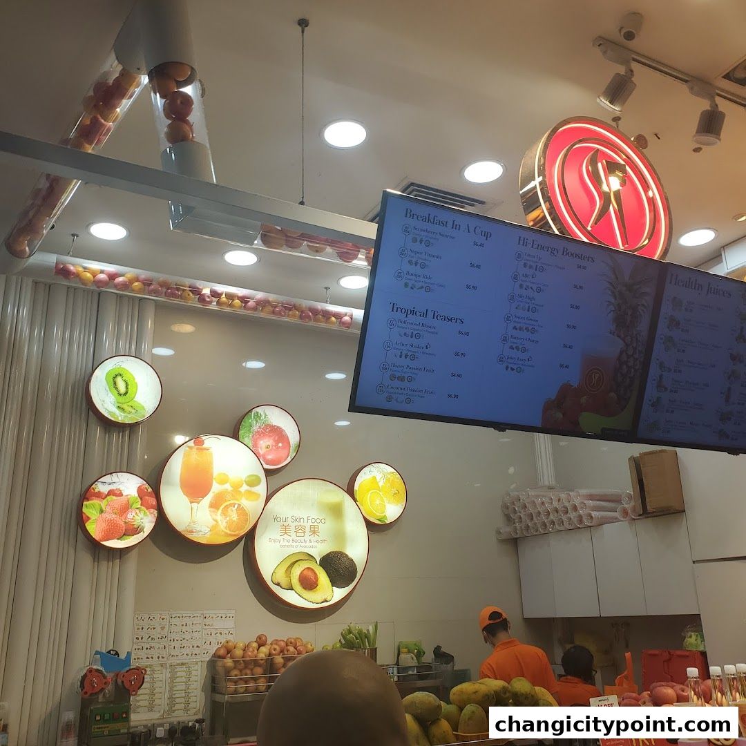 A digital menu board displaying various fruit juice options and prices at SF Fruits Juices.