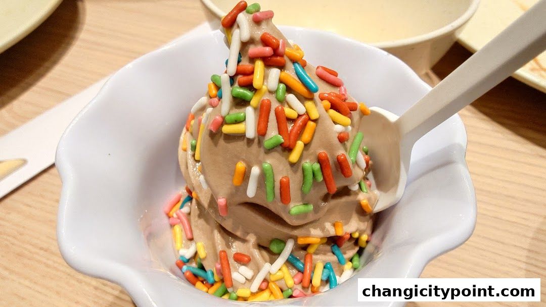A close-up of chocolate soft-serve ice cream topped with colorful sprinkles in a white bowl.