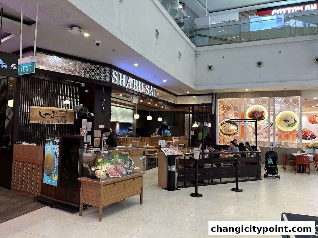 The entrance of Shabu Sai restaurant with a display of fresh ingredients and seating area.