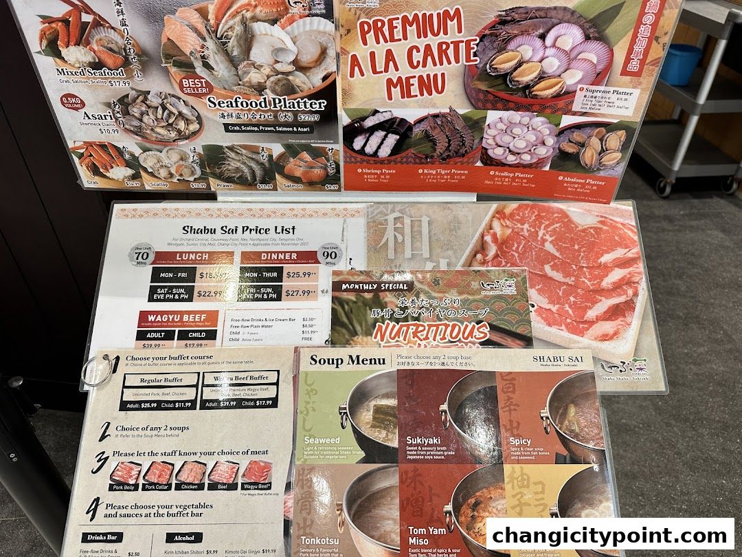 A display of Shabu Sai menus showcasing seafood platters, a la carte options, and soup bases.