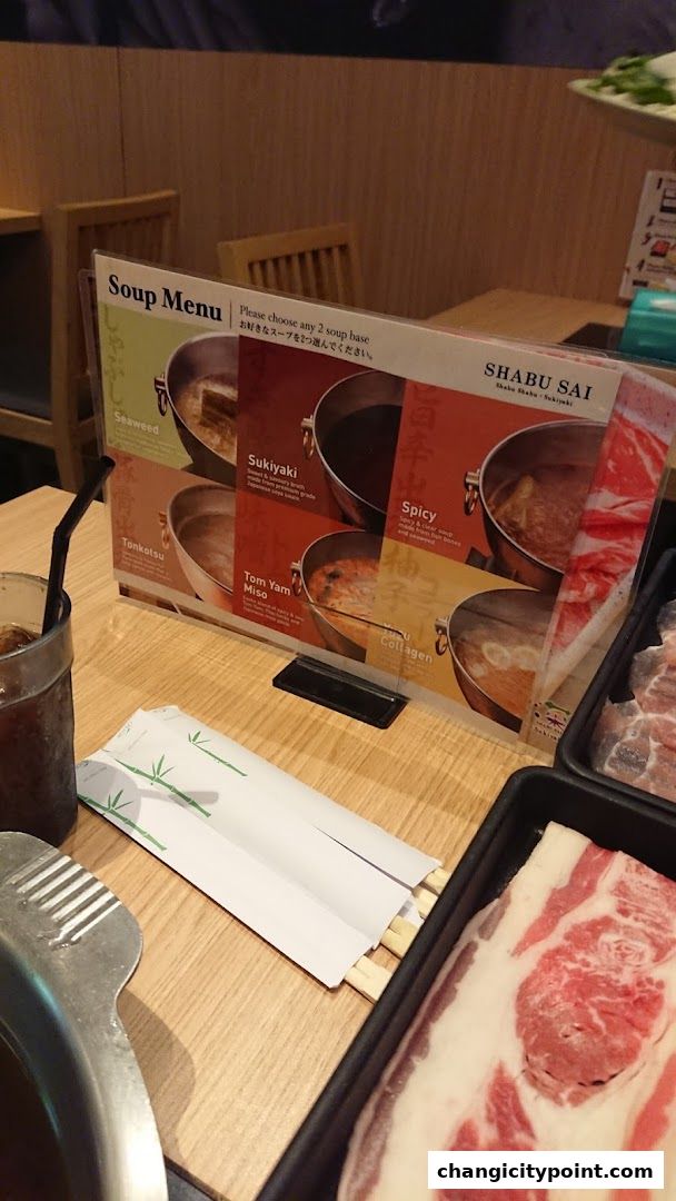 A Shabu Sai soup menu with various broth options and raw meat.