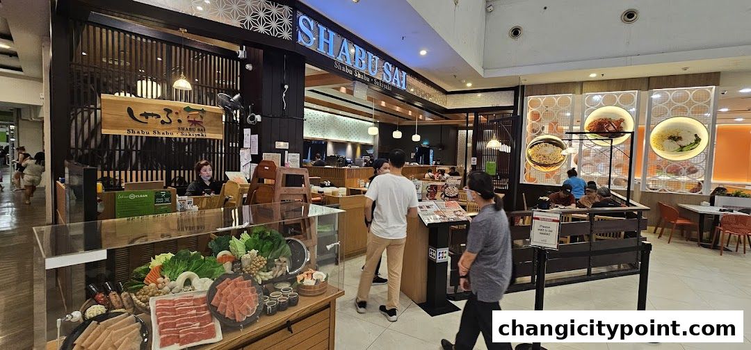 The entrance and interior of Shabu Sai restaurant, showcasing fresh ingredients and dining area.