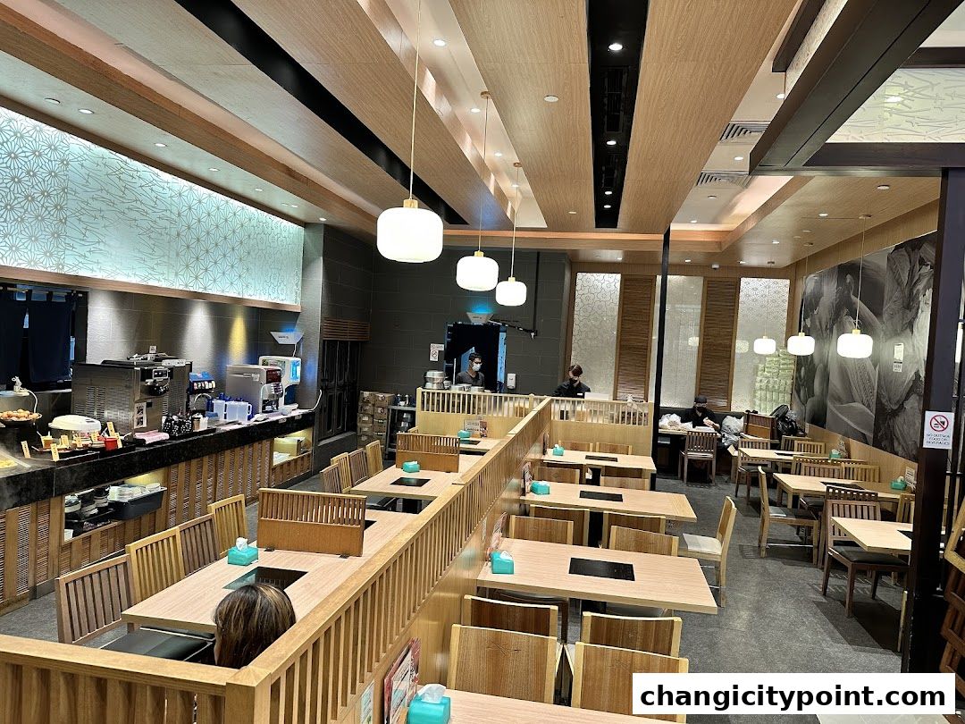 Interior view of a Shabu Sai restaurant with tables set for dining and a buffet counter.