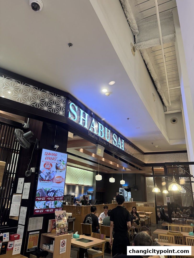 The entrance of Shabu Sai restaurant with a digital menu displaying seafood options.