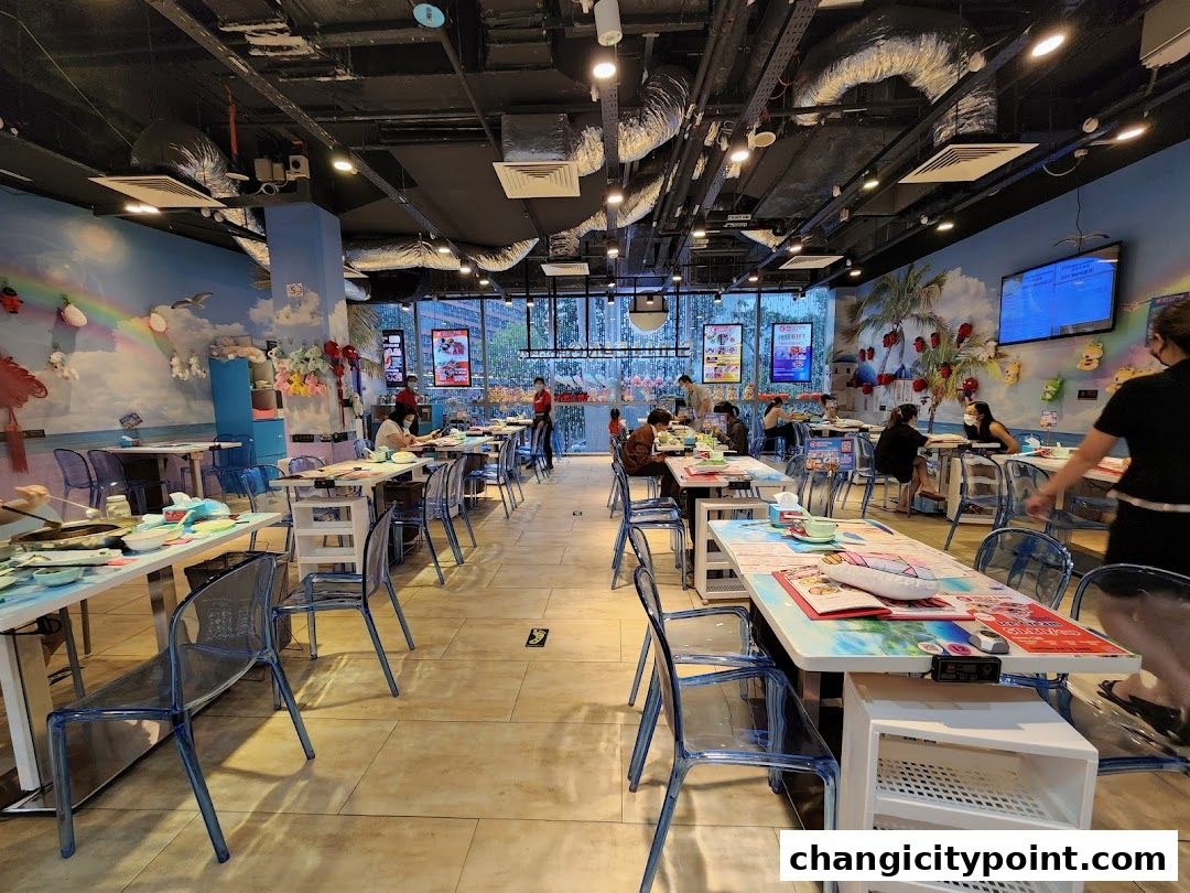 Interior of a hot pot restaurant with tables, chairs, and decorative walls.