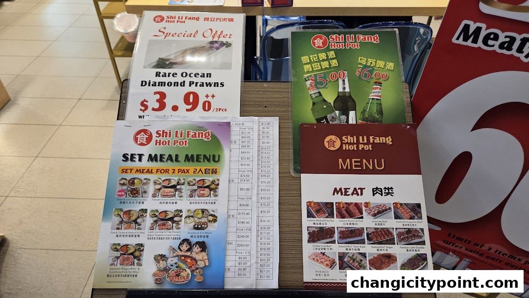 A display of menus and special offers for Shi Li Fang Hot Pot.