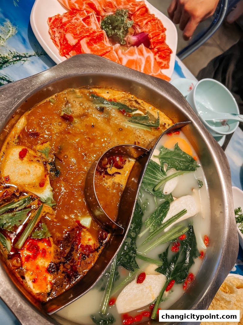 A split hot pot with spicy and clear broths, served with thinly sliced beef.