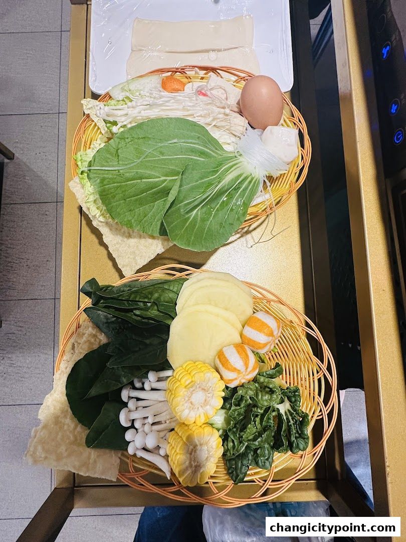 Two woven baskets filled with fresh hot pot ingredients, including vegetables, mushrooms, and an egg.