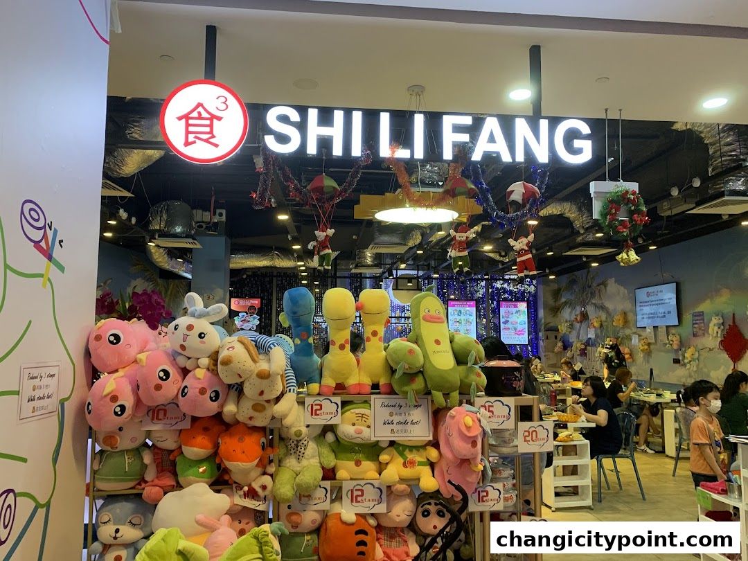 A shop interior with plush toys displayed in front of a hot pot restaurant.