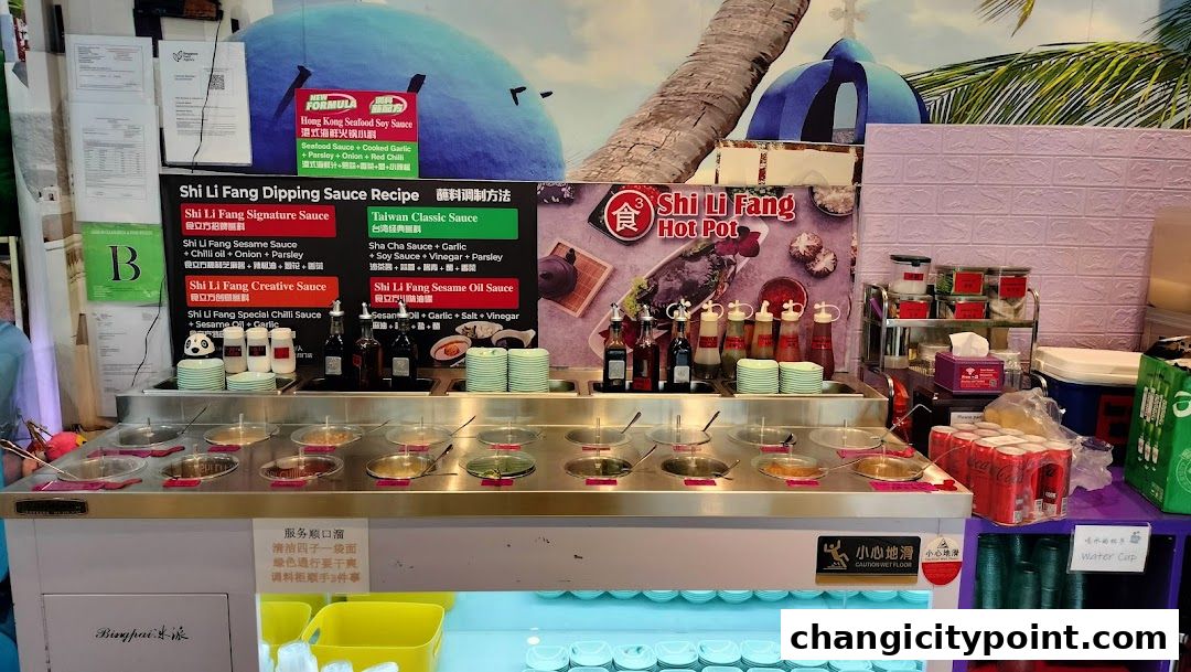 A hot pot restaurant's dipping sauce station with various sauces and ingredients.