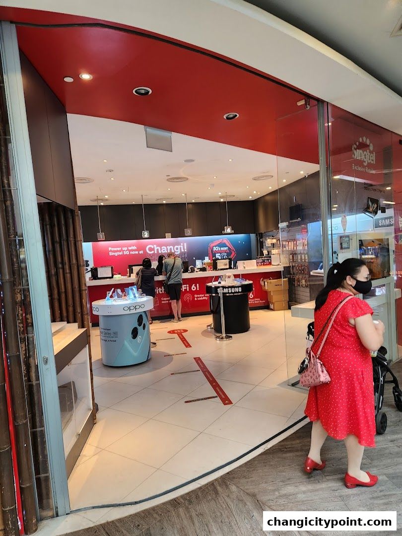 Entrance to a Singtel Exclusive Retailer shop at Changi City Point with displays and staff.