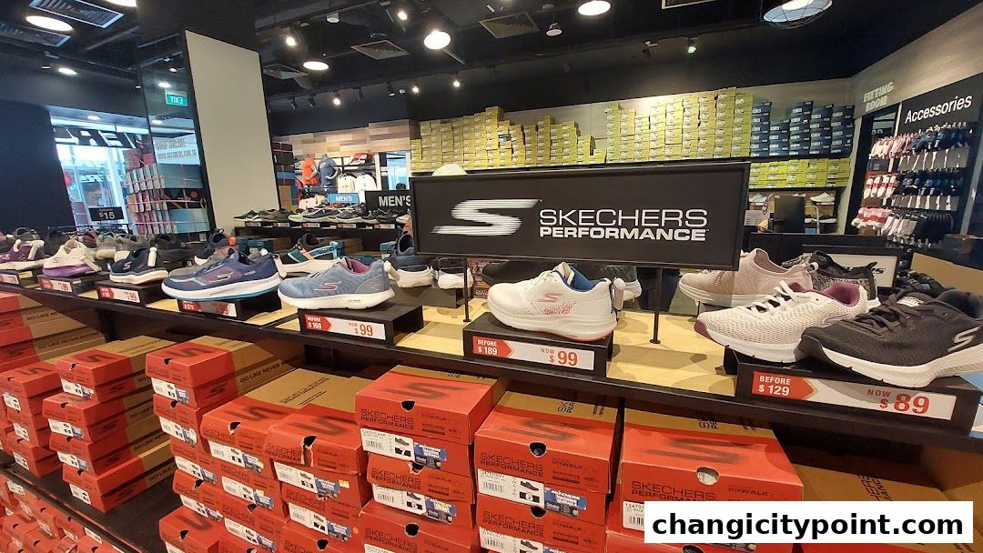 Interior view of a Skechers store showcasing various shoes and stacked shoe boxes.