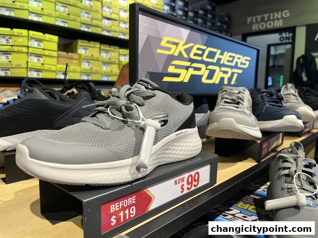 Skechers Sport shoes on display with sale price tags and fitting room sign.