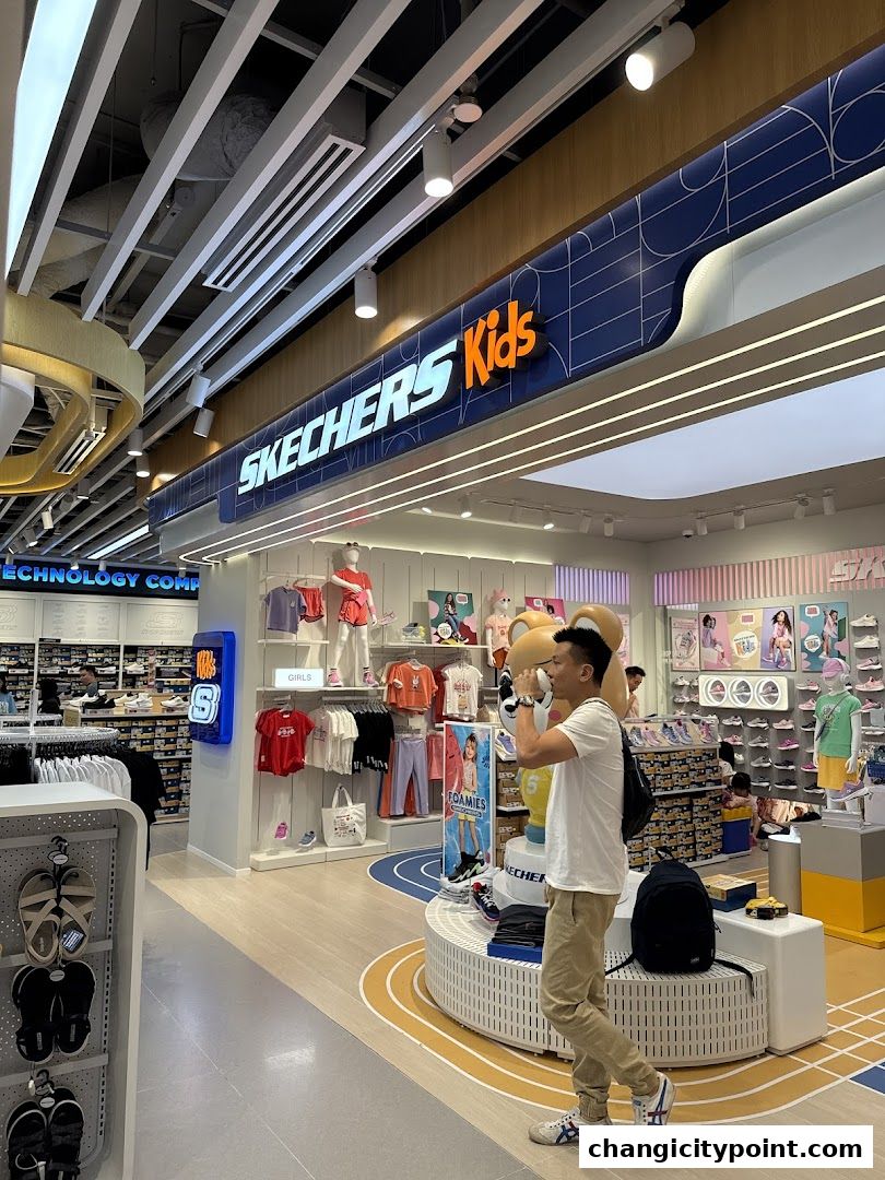 Interior of a Skechers Kids store with shoes and apparel displayed.