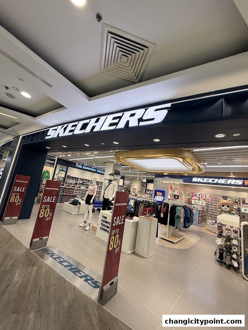 Skechers store entrance with sale signs and mannequins displaying apparel.