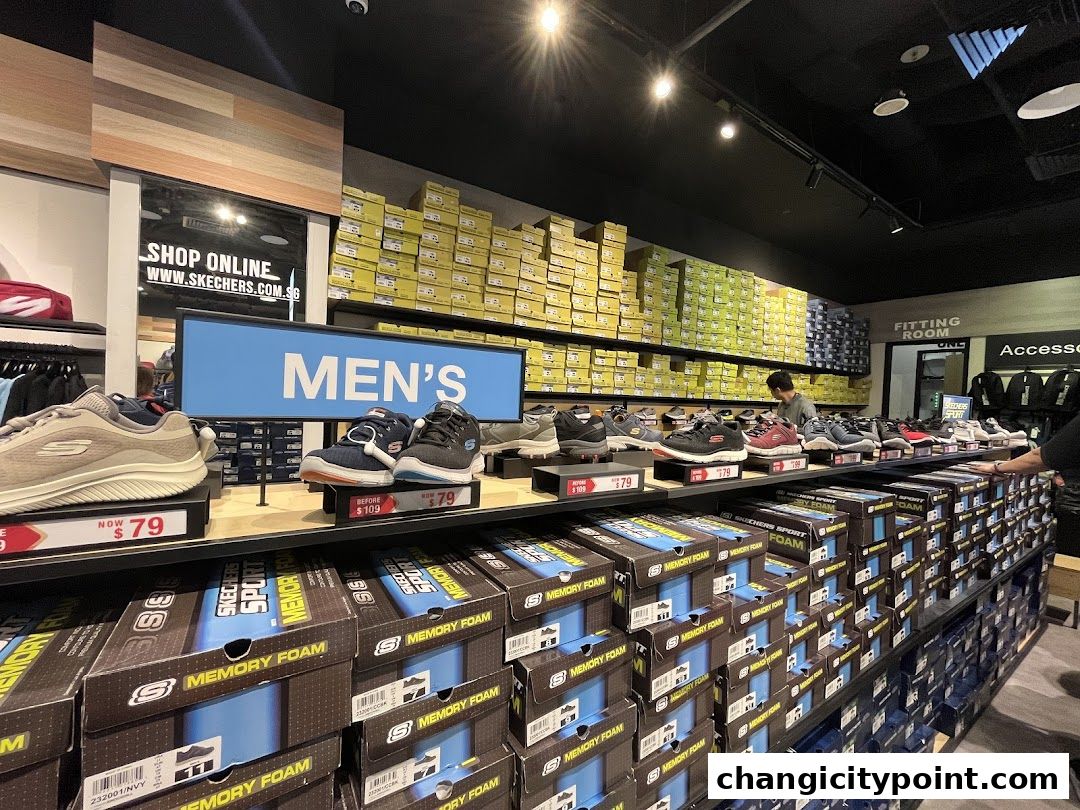 Interior of a Skechers outlet store showcasing men's shoes and stacked shoe boxes.